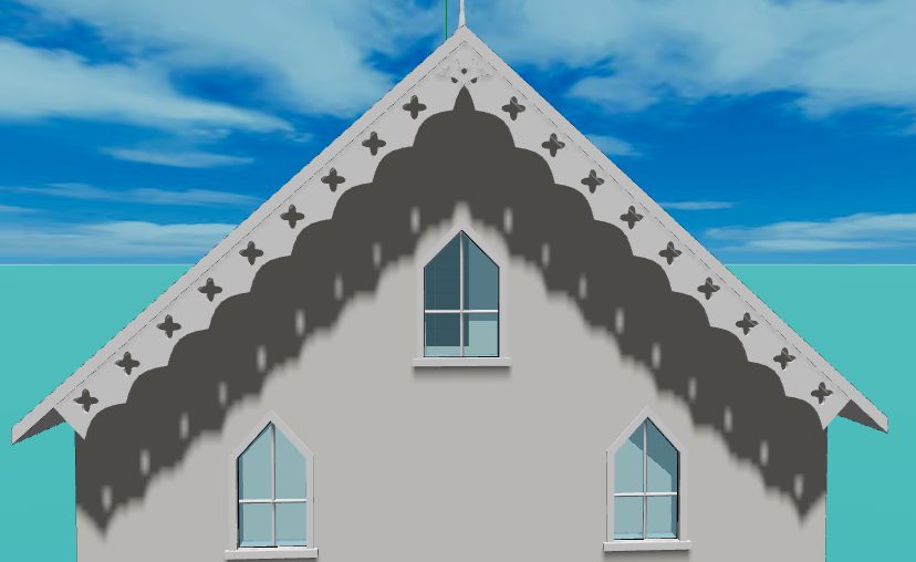 A gable end with a tracery bargeboard: a deeper board cut through with quatrefoils