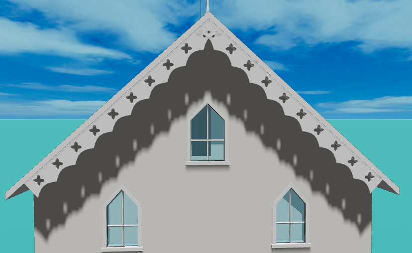 A gable end with a tracery bargeboard: a deeper board cut through with quatrefoils